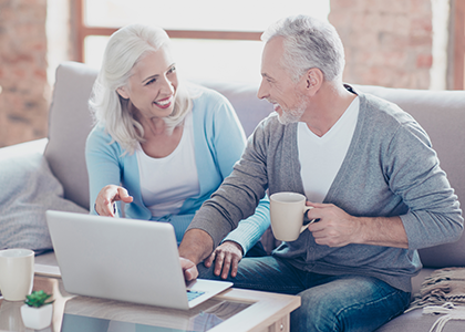 Couple laughing at something on the computer